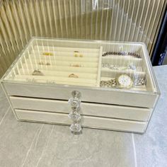 a white jewelry box sitting on top of a counter