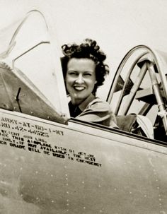 a woman sitting in the cockpit of an airplane