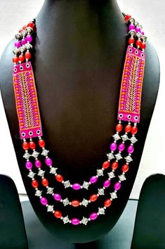 "Enjoy wearing this colorful, joyful novelty multi strand jelly bean necklace, in bright, fun colors. It looks good enough to eat! Great gift for grandmother - bright colors and light weight, no strain on her neck. Easy to pack, it is perfect for travel, tropical vacation, beach wear, resort wear, cruise wear. Gold colored crystals add bling! Looks great on everyone! Kick your wardrobe up a notch! - length 12 -14\", adjustable via sliding bead to 19\" - detailed silver tone beads add interest - Bohemian Pink Necklace With Polished Beads, Traditional Pink Necklaces With Colorful Beads, Red Jewelry For Beach Festivals, Fun Red Jewelry With Colorful Beads, Colorful Beads Jewelry For Beach Festivals, Colorful Beads Necklace For Beach Festivals, Multicolor Multi-strand Jewelry For Festivals, Handmade Pink Beaded Necklaces For Festive Occasions, Handmade Multi-strand Beaded Necklaces For Festivals