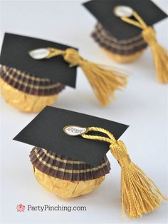 three graduation caps with tassels on them are shown in gold and black paper