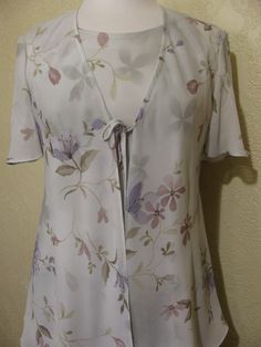 This is a very pretty 2 piece sleeveless long layered dress with matching long sheer chiffon jacket by r&m richards. still in brand new condition. it is a size 8. please go by the measurements below for proper fit. very elegant pretty women look. perfect for a garden party or summer wedding. the dress has a modest scoop neckline with a small keyhole button back. the dress is made of a pastel light sage green floral print crepe chiffon. the flowers are very light pastels of pinks and periwink Spring Formal Dress With Open Front, Spring Formal Open Front Dresses, Spring Formal Dress With Overlay, Spring Open Front Flowy Dresses, Flowy Open Front Spring Dress, Flowy Open Front Dress For Spring, Fitted Open Front Dress For Spring, Long Layered Dress, Sage Green Floral Dress