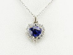 We've set this classic pendant with a deep blue sapphire of excellent quality. The setting is filled with bright white diamonds, reflecting brilliance and life into this gorgeous gemstone. This pendant does not come with the chain shown. Please feel free to contact us, we will help you find the perfect chain for your style and budget! Metal: 18K White Gold Gem: Sapphire 1.03 Carats Gem Measurements: 5.7 x 7.1 mm, Pear Cut Accents: 12 Diamonds totaling .36 Carats, G in Color, VS in Clarity Measurements: 11 x 16 mm, with bail Marks: "18K" Stamped on the reverse Formal Sapphire Heart Pendant Jewelry, Sapphire Pendant Diamond Necklace In White Gold, Sapphire Gemstone Diamond Pendant Necklace, Sapphire Gemstone Pendant Diamond Necklace, Sapphire Diamond Cut Necklace, Sapphire Diamond Cut Pendant Necklace, Sapphire Diamond Pendant Necklace, White Gold Sapphire Heart Pendant Jewelry, Anniversary Sapphire Pendant Diamond Necklace