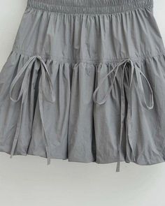 A chic skirt featuring a bubble hem design, elastic waistband, and adjustable drawstring details for a playful style. 100% PolyesterMade in Made In China Bubble Hem Skirt, Buckle Bunny, Chic Skirt, Playful Style, Chic Skirts, Bubble Hem, Hem Skirt, Gray Skirt, Made In China