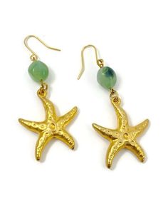 These adorable earrings are the perfect accessory for any beach lover or mermaid at heart.  The detailed starfish design in a gold tone metal adds an elegant touch and the green bead adds a natural touch to these dangle earrings. These have gold tone ear wires for those with pierced ears and the dangle length is 2.25" inches in length. To view more from 'NEW VINTAGE FOR YOU' go here: https://newvintageforyou.etsy.com All vintage items are sold as is in pictured condition. I do not alter or repai Gold Metal Jewelry With Starfish Charm, Gold Jewelry With Starfish Charm, Summer Gold Jewelry With Star Charm, Gold Star Charm Jewelry For Vacation, Bohemian Gold Starfish Jewelry, Gold Jewelry With Star Charm For Vacation, Gold Starfish Jewelry For Vacation, Handmade Green Starfish Jewelry, Handmade Green Starfish-shaped Jewelry