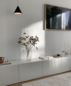 a vase filled with flowers sitting on top of a white shelf