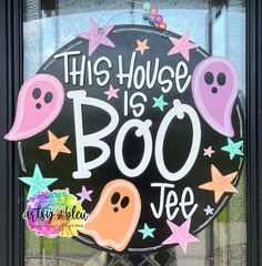 this house is boo - jee door sign with ghost faces and stars on it