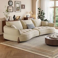 a living room filled with lots of furniture next to a large window and wooden floor