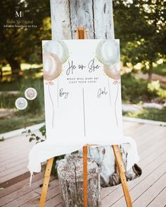 an easel with a sign and balloons on it