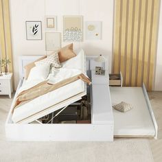 a white bed sitting in a bedroom next to a wall with pictures on it's side