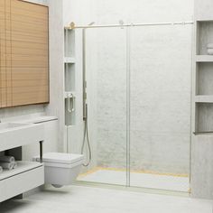 a bathroom with a toilet, sink and shower stall in the middle of the room