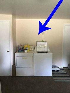 a white washer and dryer sitting next to each other in a room