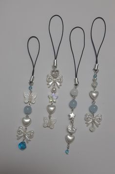 four different necklaces with charms attached to them