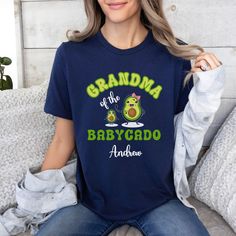 With love we made this CUSTOMIZABLE GRANDMA SHIRT of a baby boy or baby girl featuring cute Nanacado and Babycado in cartoon style. All embellished with the name of Grandchild and the text GRANDMA OF BABYCADO plus kid name. This FUNNY AVOCADO GRAMMY tee is the PERFECT PROPOSAL FOR NEW GRANDMOM from Children on the occasion of the first grandchildbirth, her first birthday as GIGI or her 1st Mother's Day as MIMI Valentine's day, Anniversary, first Christmas as GRAMMIE. This CUTE PERSONALIZED AVOCA Cute T-shirt With Name Print For Gift, Cute T-shirt For Father's Day Gift, Family Matching Custom Name T-shirt As A Gift, Family Matching T-shirt With Custom Name As Gift, Cute Blue T-shirt For Gift, Blue T-shirt For Mother's Day Gift, Playful Personalized T-shirt For Gift, Playful Personalized T-shirt As Gift, Custom Name Family Matching T-shirt