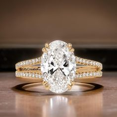 an oval cut engagement ring set with diamond band and side stones in yellow gold setting