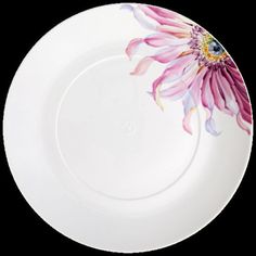 a white plate with a pink flower painted on the front and center piece is shown