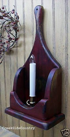 a candle holder is mounted on the wall