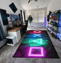 a room that has a rug on the floor with different colors and shapes in it