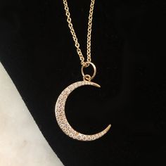 Our stunning crescent moon charm is a great addition to any layer up of symbols and talismans. The moon can represent changes through time as the moon goes through phases and is also a symbol of the Goddess Diana who was patron goddess of the moon. Sterling silver plated in 14K gold with cubic zirconia stones. 16" chain with extension. All orders over $50 ship for free within the USA. All orders usually ship within 24 hours from the USA. Celestial Crescent Moon Phase Necklace, Elegant Half Moon Charm Jewelry, Elegant Crescent Moon Phase Jewelry, Diamond Half Moon Charm Jewelry, Elegant Crescent Moon Charm Jewelry, Symbolic Crescent Moon Phase Necklace, Diamond Half Moon Phase Necklace, Diamond Moon Charm Necklace With Round Pendant, Celestial Crescent Diamond Jewelry