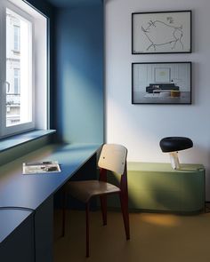 a room with a chair, desk and pictures on the wall above it in front of a window