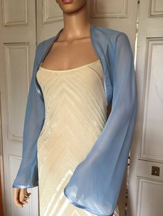 This is a beautiful hand made light blue shrug ideal for weddings or special occasions. It can also be worn with casual wear. It can be made in any size from 8 to 24 (UK sizes). It is made in the UK. It is normally sent out to you within 5 days, but I am very happy to make your order a priority if you need it urgently. Just let me know the date needed by. Postage is free in the UK! International postage is £9. I am happy to exchange items or refund your payment if you are less than happy with th Light Blue Dress With Long Sleeves, Prom Dress Cover Up Jackets, Prom Cover Up, Bolero And Dress, Dress Coverup Ideas, Satin Shrug, Bali Fits, Gown With Shawl, Blue Shrug