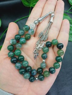 This listing is for 1 pc 33 beaded tasbih. Product Details: 💚 Bead size: 10 mm  💚 Bead count: 33 beads 💚 Bead cut: Round  💚 Gemstone: Moss Agate  💚 Spacers: Silver colored metals 💚 Gemstone Quality: AAA Grade (High Quality) 💚 Cord: Parachute thread ✔️ 33 beaded Islamic Misbaha ✔️ 10 mm big size Moss Agate gemstone Rosary  ✔️ Natural Green Color Tasbeeh  ✔️ Luxury Natural Aqiq Stone Tesbih  ✔️ High grade large Moss Aqeeq Stone beads ✔️ Silver colored metal aparats  ✔️ Strong Parachute thre Jade Beads Gems And Cabochons For Gifts, Jade Round Beads For Gifts, Polished Jade Beads For Spiritual Use, Spiritual Polished Jade Beads, 8mm Agate Beads As Gifts, Round Agate Beads For Gifts, Polished Agate Beads For Gift, Gift Agate Polished Beads, Spiritual Round Agate Beads