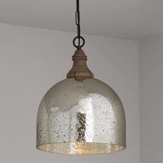 a light hanging from a ceiling in a room with white walls and gray flooring