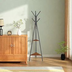 a living room scene with focus on the sideboard and floor lamp next to it