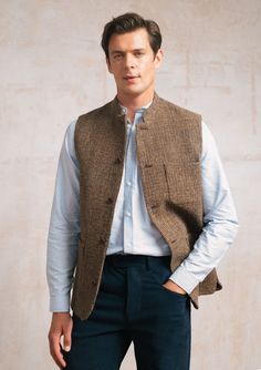 Welcome our newest addition - the Brown Harris Tweed Waistcoat. Handwoven in the Outer Hebrides of Scotland from pure virgin wool, Harris Tweed is the fabric of choice wherever quality and provenance are valued. A classic single-breasted design with our signature Nehru collar offers a contemporary silhouette. It features a smooth viscose lining for easy layering, sustainably sourced Corozo nut buttons and roomy patch pockets. Dress up with a grandad shirt or down with a crew neck jumper. Mens Waistcoat Fashion, Tweed Waistcoat, Mens Waistcoat, Waistcoat Men, Crew Neck Jumper, Outfit Combinations