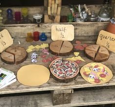 several wooden signs are on display in front of other woodworking tools and crafts items