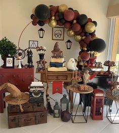 a room filled with lots of different types of decorations and balloons hanging from the ceiling