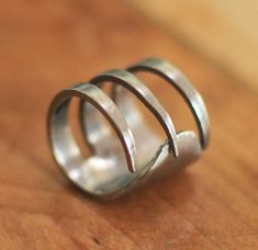 a silver ring sitting on top of a wooden table