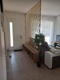 a living room filled with furniture next to a wall mounted flat screen tv on top of a wooden shelf