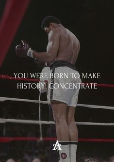 a man standing on top of a boxing ring