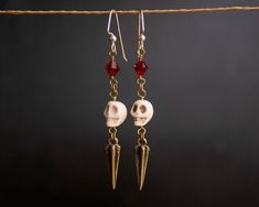 A great pair of earrings to add your Pirate or Steampunk aesthetic into your everyday wear. Created with ivory toned carved howlite skulls, these earrings have beautiful Swarovski Elements Crystals in Siam red. The pair will come with clear rubber wire stoppers to secure them while wearing. I draw inspiration from my studies of history, from ancient times to modern, as well as from media inspired by history. Because of this my pieces may be influenced by Ancient Roman styles, tribal styles of th Pirate Jewelry Aesthetic, Pirate Earring, Pirate Earrings, Punk Pirate, Red Halloween, Gothic Culture, Pirate Jewelry, Steampunk Aesthetic, Medieval Festival