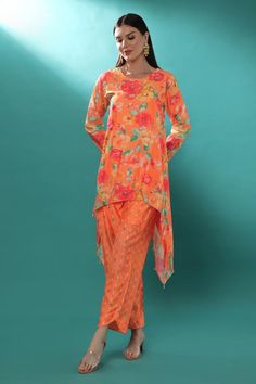 Orange chanderi high-low tunic with floral print and sequins, pearls and cutdana embroidery. Comes with pant.
Components: 2
Pattern: Printed, Embroidered
Type Of Work: Floral, Sequins, Pearls, Cutdana
Neckline: Round
Sleeve Type: Full
Fabric: Chanderi, Lining : Shantoon
Color: Orange
Other Details: 
Attached lining
Length :
Tunic : 28 inches (Front), 45 inches (Side)
Pant : 38 inches
Product Weight : 1 Kg
Closure : Tunic - Back hook
Occasion: Sangeet - Aza Fashions Traditional Semi-stitched Pant Set With Sheer Dupatta, Bollywood Style Pant Set With Sheer Dupatta For Eid, Summer Chanderi Palazzo Set With Straight Kurta, Summer Chanderi Long Sleeve Sets, Georgette Long Sleeve Pant Set With Dupatta, Long Sleeve Georgette Pant Set With Dupatta, Summer Long Sleeve Chanderi Sets, Summer Sets With Sheer Dupatta And Traditional Drape, Spring Designer Wear Straight Kurta Set