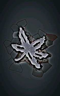 an abstract image of a snowflake in black and white on a dark background