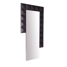 a mirror that is on the wall with some black and white tiles around it's edges