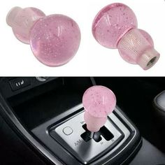 two pink car air fresheners sitting on top of a dashboard