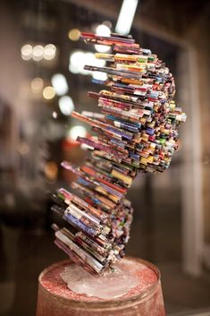 a stack of magazines sitting on top of a jar