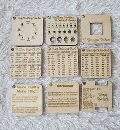 several wooden tags with numbers on them sitting on a white blanket next to each other