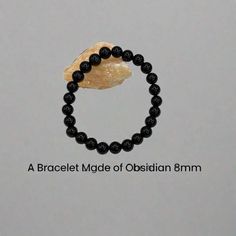 Immerse yourself in the elegance of our unique, one-of-a-kind Black Obsidian Stretch bracelet. Crafted from genuine 8mm Obsidian, known for its protective qualities and connection to the root chakra. This Bracelet stands as not just a fashion accessory, but a statement of harmony and balance. Its stretchy design ensures a comfortable fit for most wrist sizes. Making it a perfect gift for a loved one or a Well-Deserved treat for yourself. Each bead is hand-selected and Meticulously threaded, refl Bracelet Stands, Black Obsidian Bracelet, Shell Wind Chimes, Purple Jasper, Obsidian Jewelry, Obsidian Bracelet, Bracelet Size Chart, Turtle Bracelet, Sea Glass Earrings