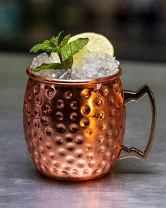 a copper mug filled with ice and mint