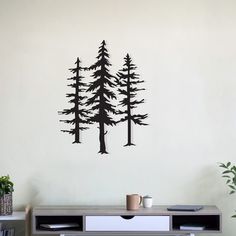 a wall decal with trees on it in a living room next to a desk