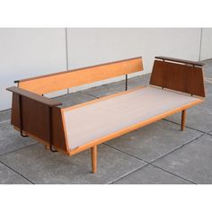 two wooden benches sitting next to each other on top of a cement floor covered ground