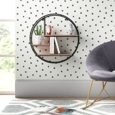 a modern living room with black and white polka dot wallpaper, a round metal shelf on the wall