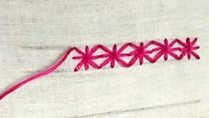 a piece of cloth with pink thread on it