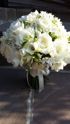 a bouquet of white flowers sitting on top of a table