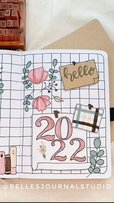 an open planner with flowers and numbers on it