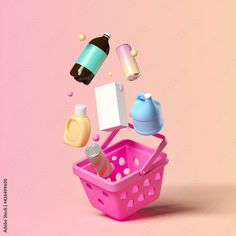 a pink basket filled with lots of bottles and other items on top of a pink background