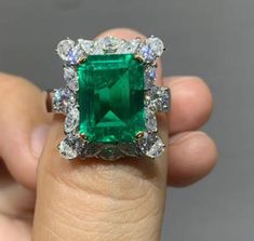 **Description Experience luxury with our exquisite **5 CT Colombian Lab-Grown Emerald ring set in lustrous 18K Gold**. This handcrafted jewel boasts a radiant octagon-shaped emerald, complemented by the sparkle of Roaya Diamond Moissanite. **Key Details - **Main Gemstone   - **Type Premium Octagon Lab-Grown Emerald   - **Size 9 x 12 mm    - **Metal   - **Type 18K Gold   - **Weight 7gm    - **Accent Stones   - **Round Brilliant Roaya Diamond Moissanite 3.5mm (2 pieces)   - **Oval Roaya Diamond Moissanite 3 x 4mm (4 pieces)   - **Marquise Roaya Diamond Moissanite 2 x 4mm (10 pieces) Indulge in the perfect blend of craftsmanship and elegance with this timeless piece. Luxury Octagon Diamond Jewelry, Luxury Green Diamond Ring With Vvs Clarity, Green Diamond Cut Diamond Ring, Luxury Green Asscher Cut Diamond Ring, Luxury Tsavorite Diamond Wedding Ring, Luxury Green Emerald Ring With Diamond Cut, Gia Certified Green Diamond Ring For Formal Occasions, Dazzling Green Diamond Ring, Green Diamond Ring For Formal Occasions